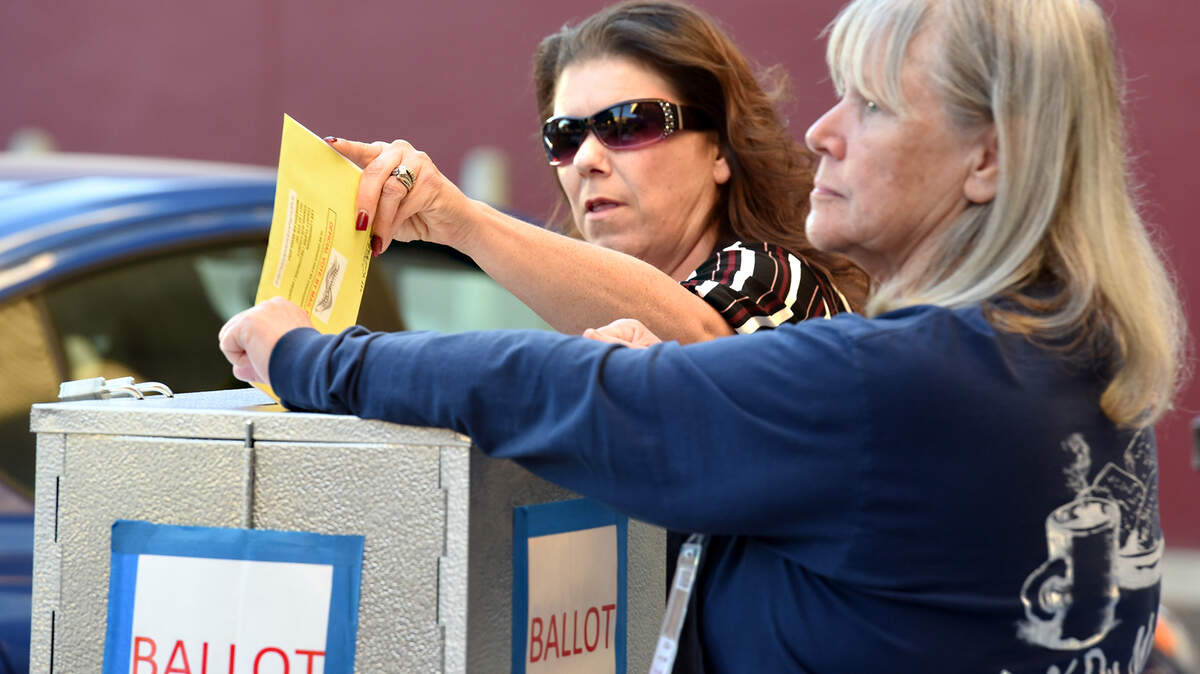 Election clerk Sondra Taylor (center) puts a ballot in the box outside the Stanislaus County Registrar of Voters on Tuesday November 6, 2018 in downtown Modesto, Calif.