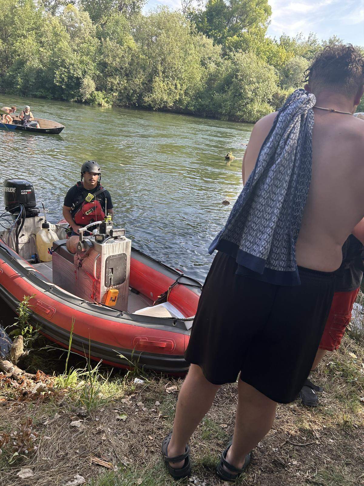 Rescue crews assist stranded individuals along the Stanislaus River after they became trapped in brush during a Memorial Day weekend water rescue in Oakdale.