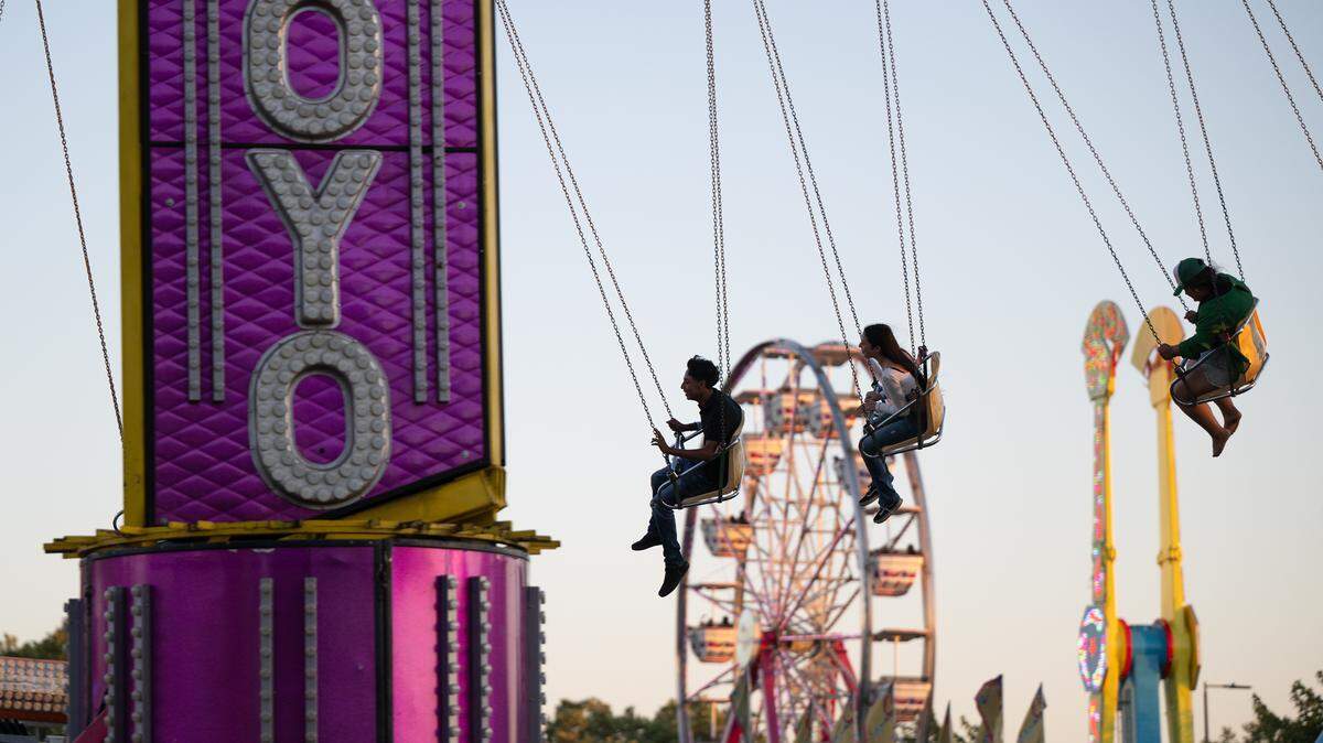 Fairgoers ride the YoYo at the Stanislaus County Fair in Turlock, Calif., Friday, July 7, 2023.