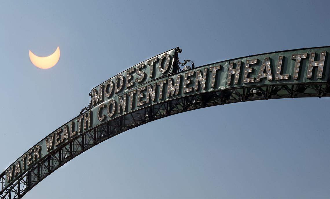 The Modesto arch in downtown Modesto, Calif. is pictured (08-21-17) in an image overlay with the first phase of the solar eclipse. An image overlay combines two photographs to create a single picture saved separately from the two originals.