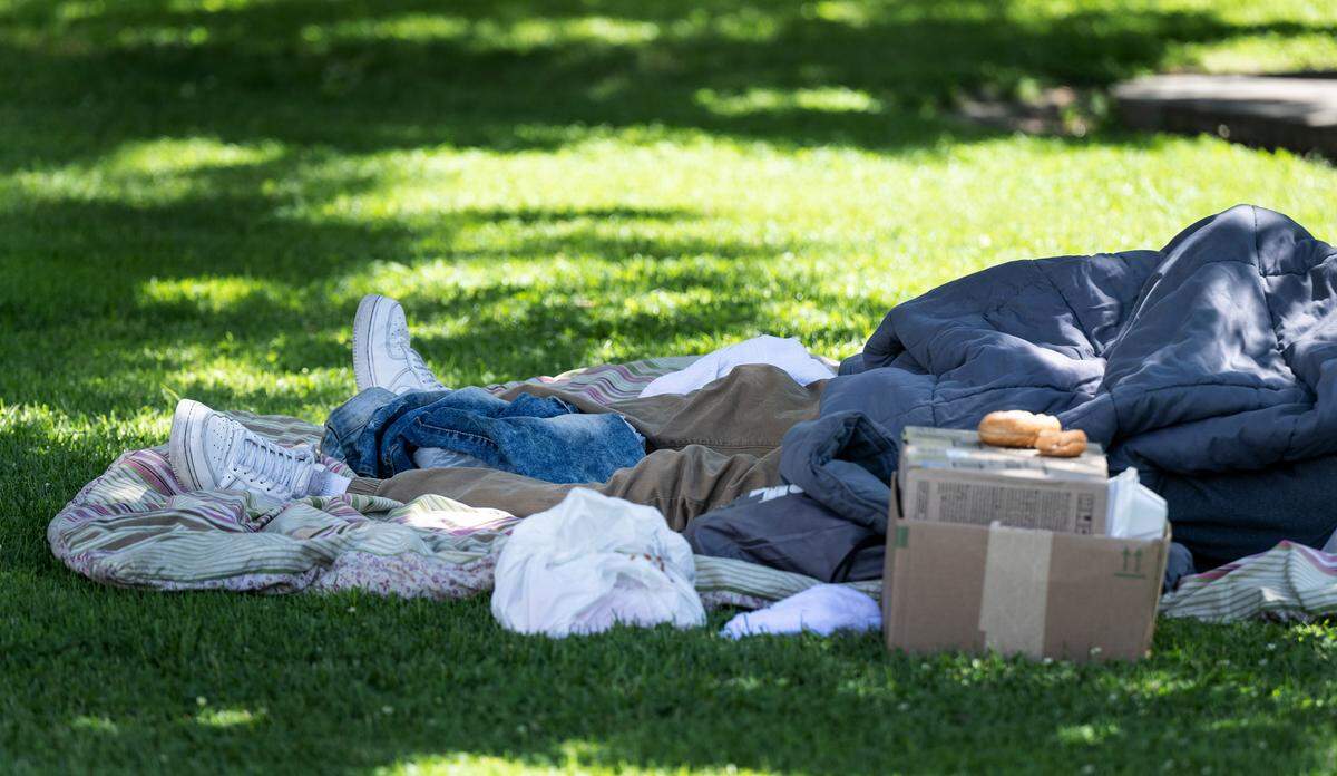 A homeless person sleeps in Courthouse Plaza in Modesto, Calif., Wednesday, May 17, 2023.