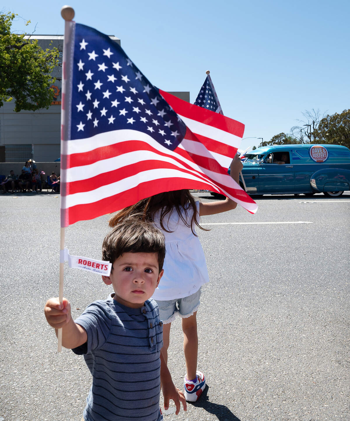 Benjamin Simon, 2, shows off his American flag during the Independence Day Parade in Modesto in 2023.