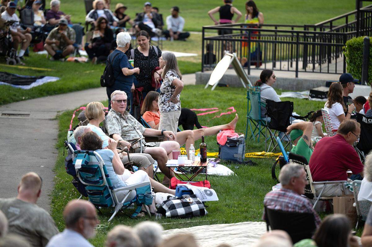 People relax and wait for the start of MoBand at Mancini Bowl in Graceada Park in Modesto, Calif., Thursday, June 8, 2023.