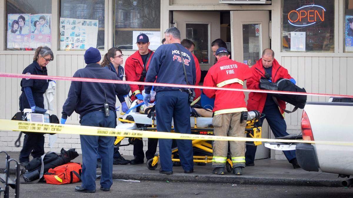 (BART AH YOU/bahyou@,modbee.com) - Modesto Police responded to a fatal shooting in a small store in the 1300 block of Yosemite Blvd, Tuesday afternoon. Three people were wounded according to MPD spokesman Sgt. Rick Armendariz. One vicitim was fatally shot. EMS transport a victim to an ambulance. January 25, 2011
