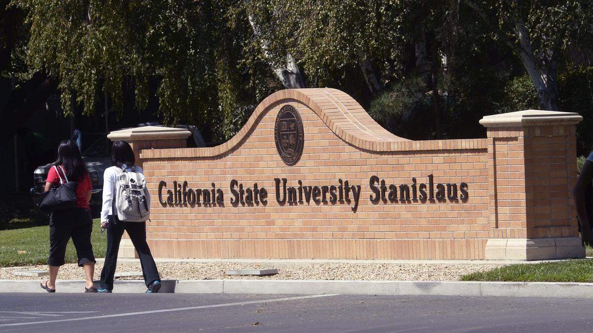 Students walk past the entrance sign at University Ave. (Monte Vista Ave.) and Dels Ln. Like other CSU campuses, Stanislaus is considering a rebranding. Stanislaus president Joseph Sheley recently asked for input during his presidential address.