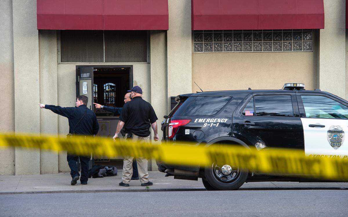 Law enforcement detectives investigate at the scene of a fatal shooting of Stockton Fire Captain Max Fortuna in Stockton, Calif., on Monday, Jan. 31, 2022.
