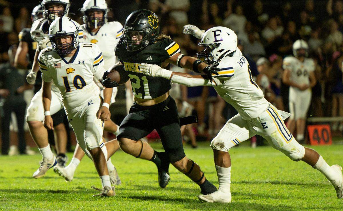 Hughson’s Eli Wilbanks fights off Escalon defenders during the Trans Valley League game in Hughson, Calif., Friday, Oct. 4, 2024.