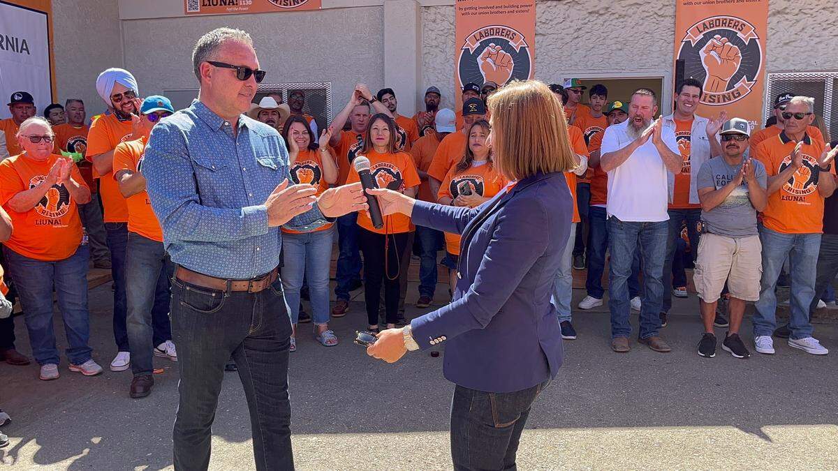 Lt. Gov. Eleni Kounalakis hands the microphone to congressional candidate Adam Gray in Modesto, Calif. on September 14, 2024.