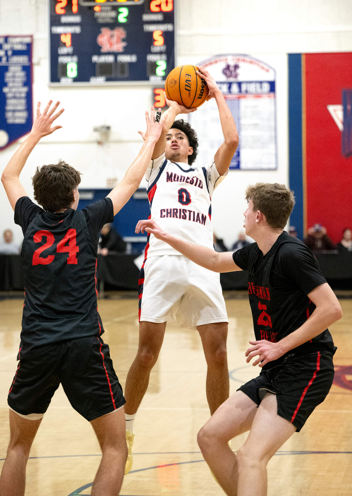 Modesto Christian’s Myles Jones shoots a jump shot over Buchanan defenders during the Holiday Hoop Classic championship game at Modesto Christian High School in Salida, Monday, Dec. 30, 2024. Modesto Christian won the game 65-54.