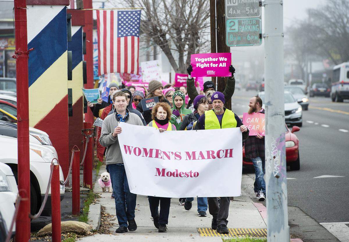 Participants walk along McHenry Avenue during the Women’s March Modesto in Modesto, Calif., on Saturday, Jan. 18, 2020.