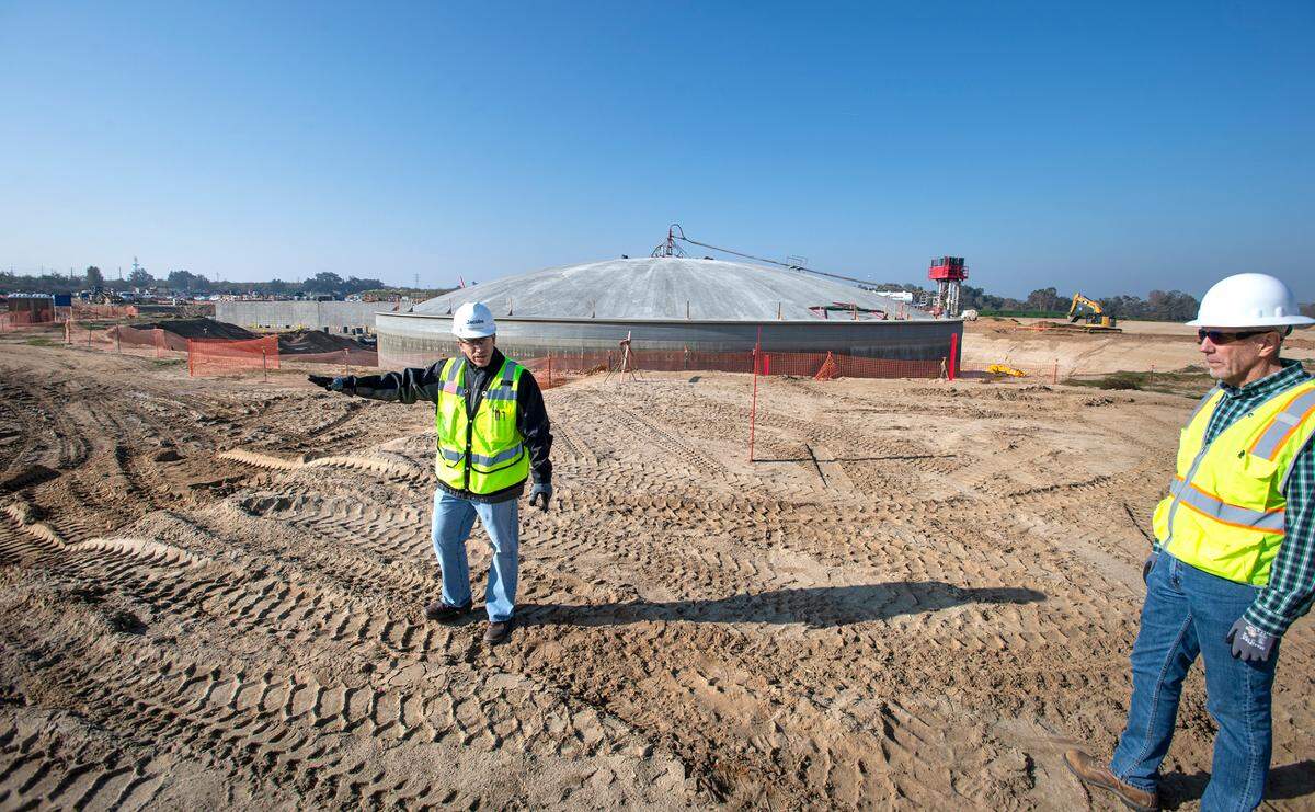 General Manager Robert Granberg, right, and Ted Michaelidis, part of the design build team, tour the site of the water treatment plant being built near Hughson, Calif., Dec. 1, 2021. The plant will treat water drawn from the Tuolumne River and will deliver drinking water to Turlock and Ceres starting in 2023.