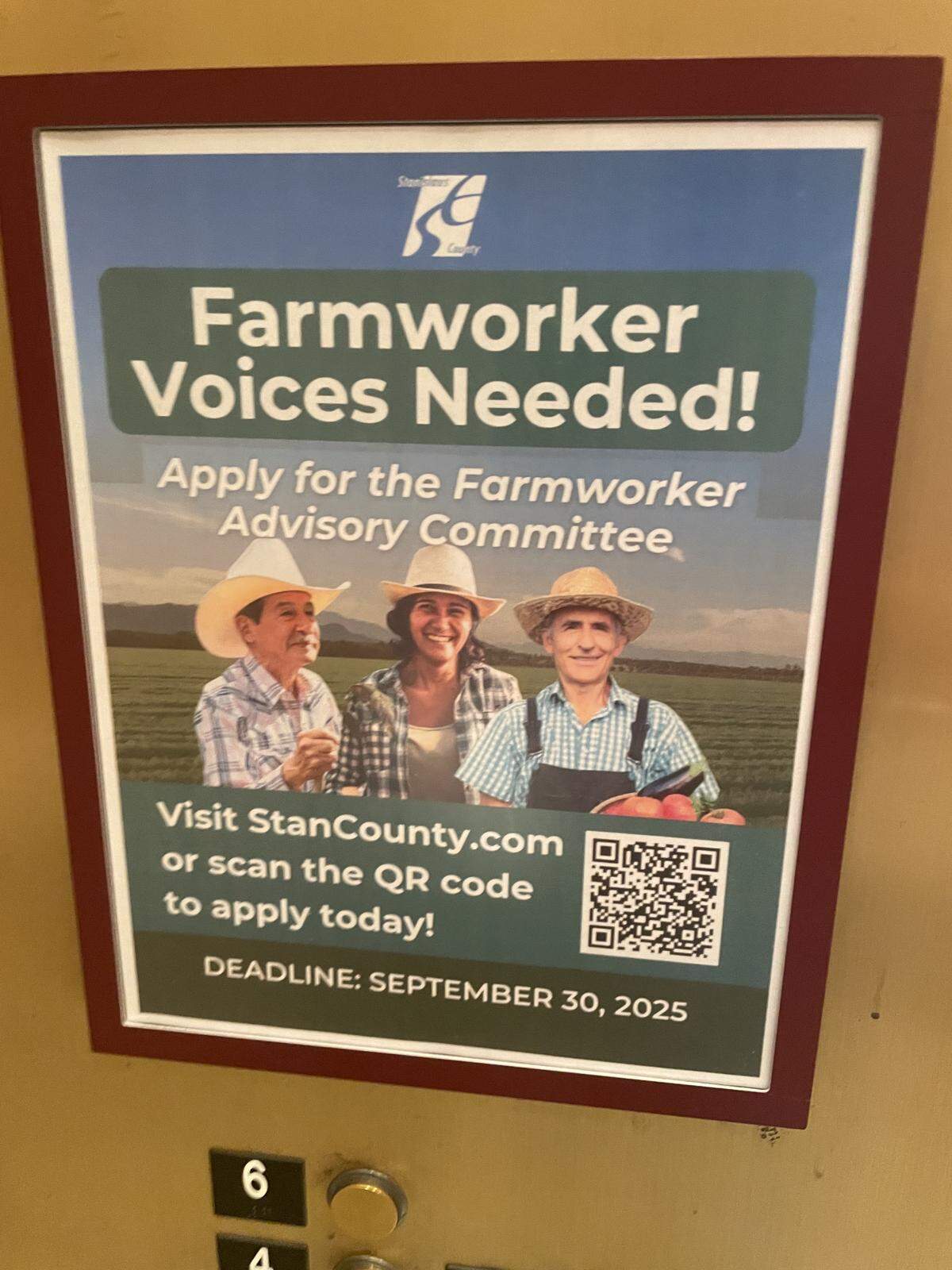 A sign seeking applicants for the Farmworker Advisory Committee hangs in an elevator at Tenth Street Place, the city/county government building in downtown Modesto.
