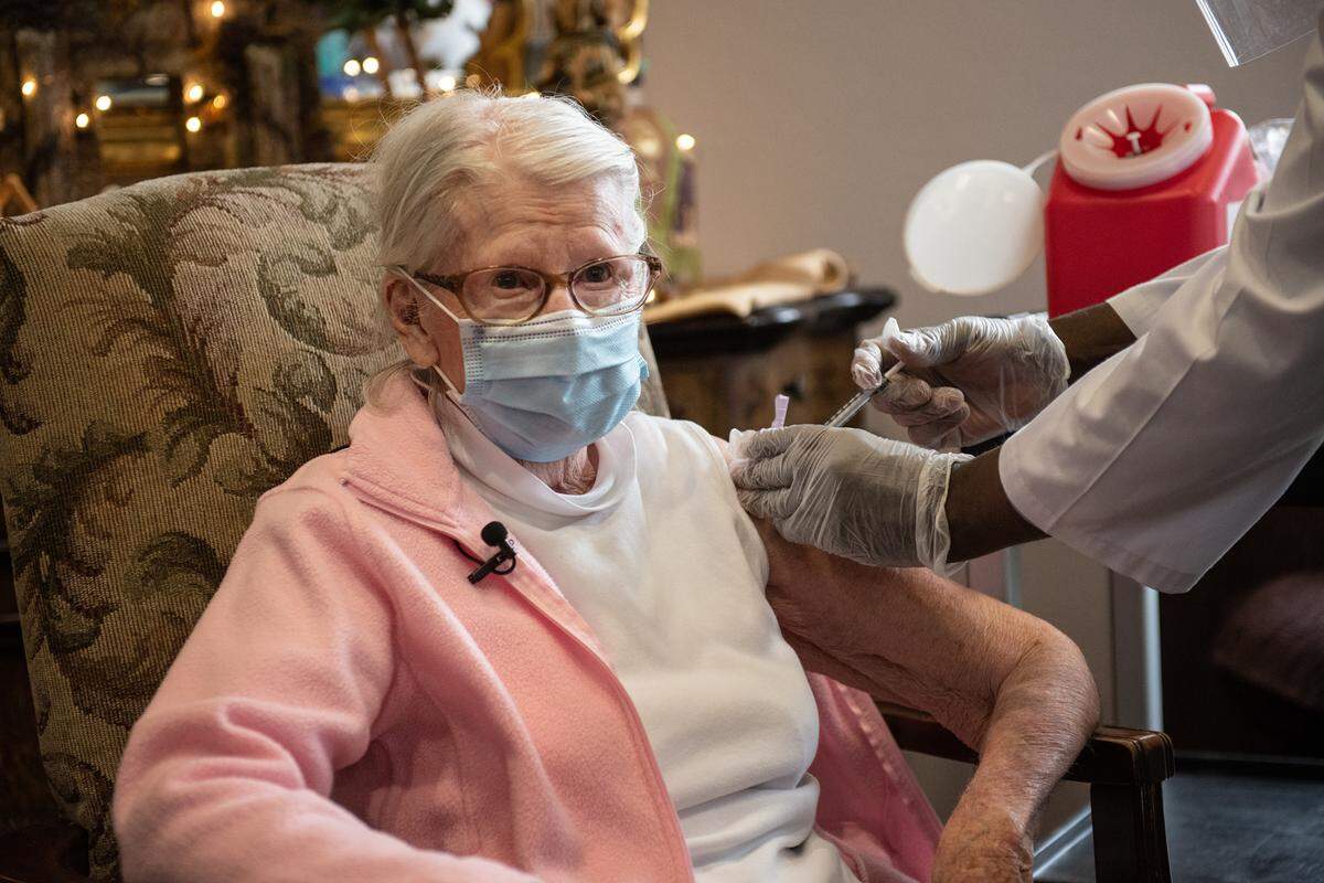 Naomi Artz, 91, receives the COVID-19 vaccine at Casa de Modesto Retirement Center in Modesto, Calif., on Thursday, August 7, 2021. The injection was administered by a CVS employee who did not want to be pictured. CVS did not allow photographs of their staff or or the preparation of the vials of the Pfizer vaccine.
