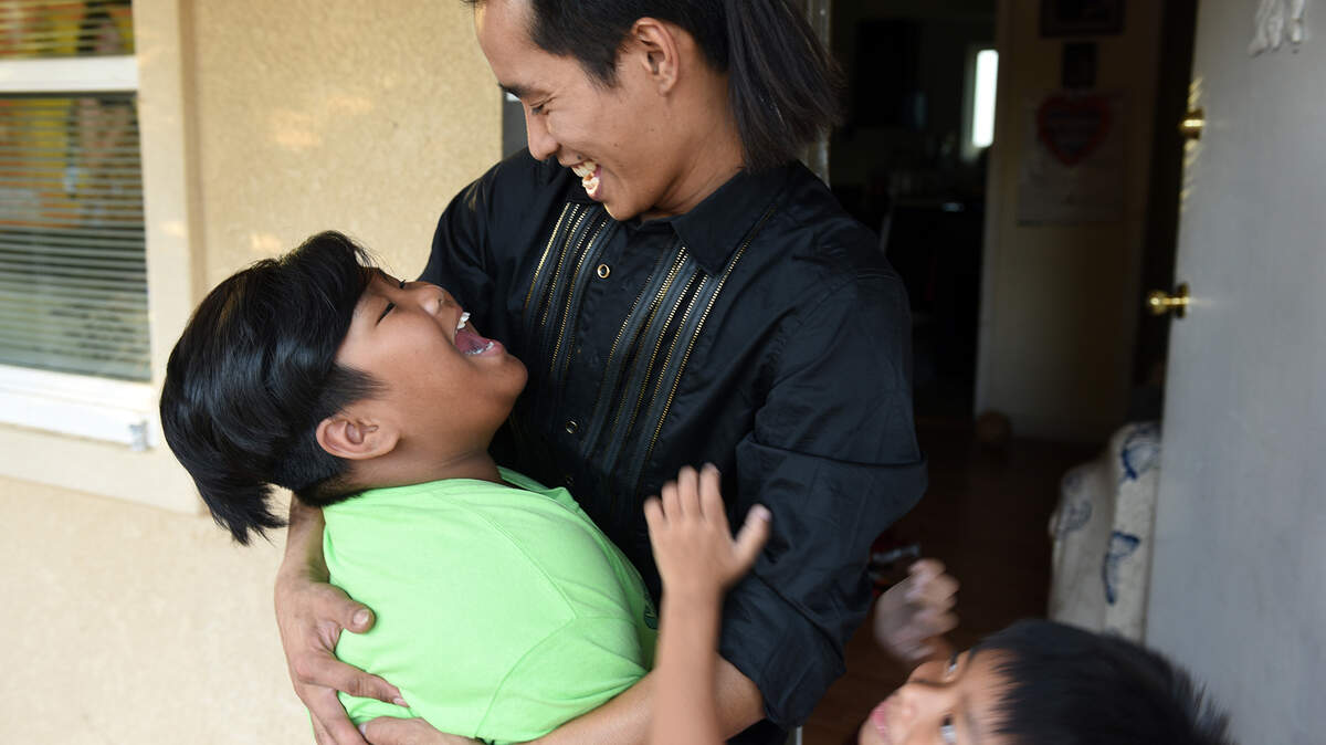 Zam Mang is pictured with his sons Thang Khai 10yrs (left) and Josiah Thang 6yrs on Monday afternoon October 21, 2019 at their home in Modesto, Calif.