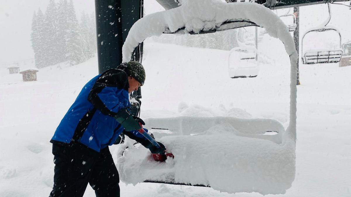 An employee of the Dodge Ridge Wintersports Area in Pinecrest shovels snow off a lift in preparation for the season opening Friday, Dec. 6, 2019.