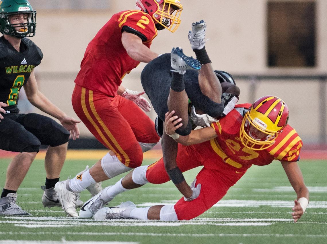 Oakdale Joshua Gerber trips up Sonora’s CJ Castleman during the non-conference league game in Oakdale, Calif., Friday, August 17, 2018. Oakdale won the game 49-0.