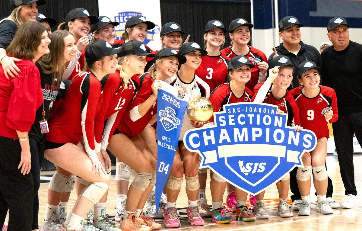 Ripon players pose for photos after winning the the Sac-Joaquin Section Division IV volleyball championship match 3-0 over Liberty Ranch at Cosumnes River College in Sacramento, Saturday, Nov. 9, 2024.