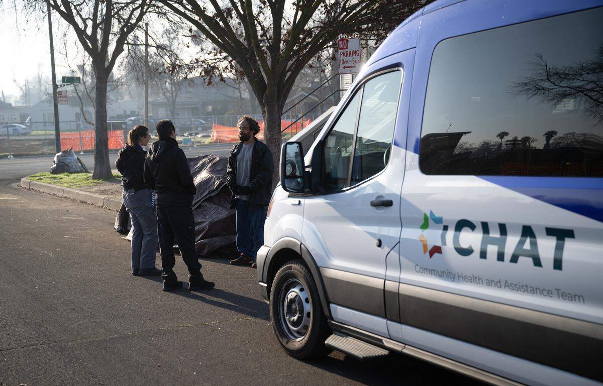 CHAT officers talk with an unhoused person during the county’s Point in Time homeless count in Modesto on Thursday, Jan. 30, 2025.