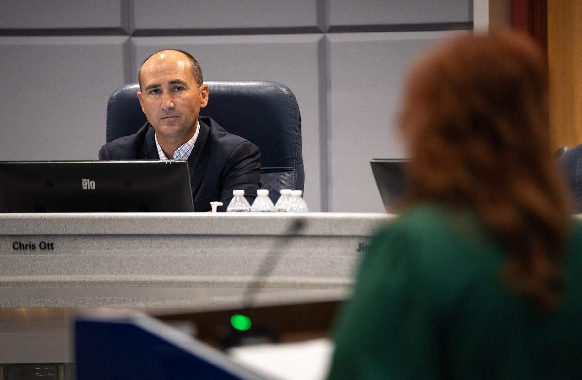 During public comment at the Modesto Irrigation District board meeting Tuesday, Aug. 12, 2025, MID director Chris Ott listens as Dana Ferreira, a regulatory analyst for MID, speaks to the  board about the alleged abuse by board member Janice Keating.