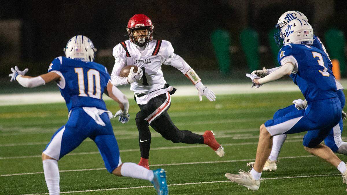 Woodland Christian’s Billy Hinkle runs into a trio of Ripon Christian defenders during the Sac-Joaquin Section Division VII championship game in November.