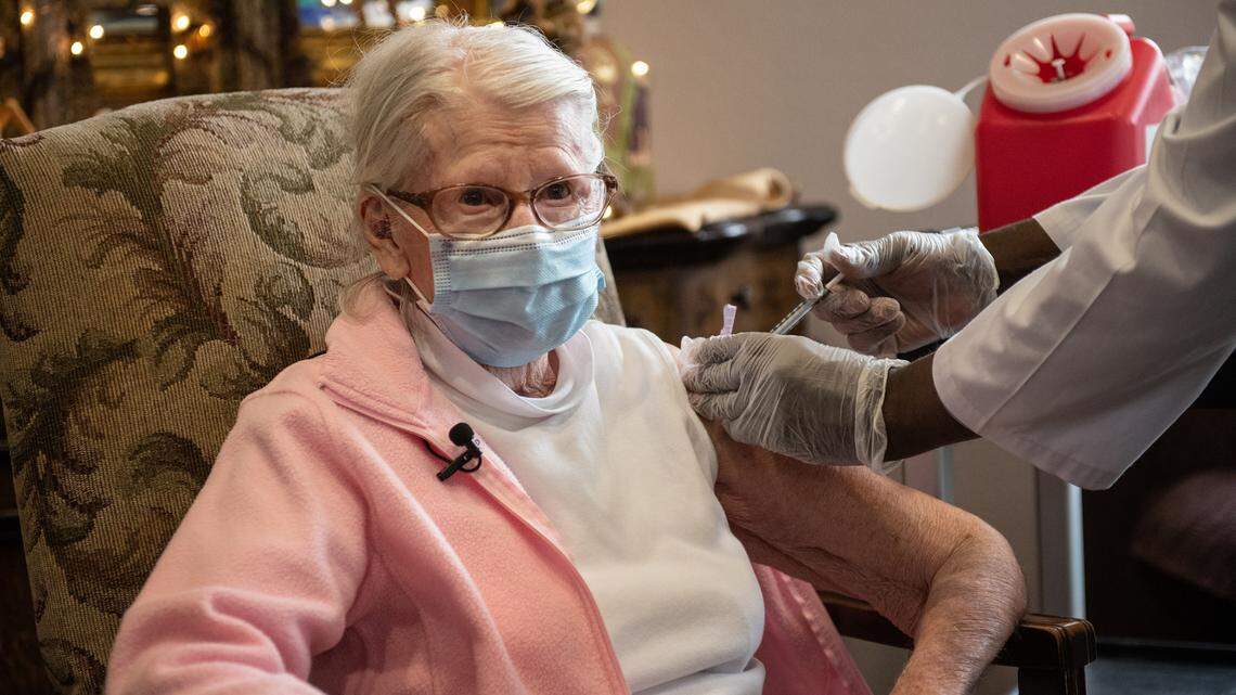 Naomi Artz, 91, receives the COVID-19 vaccine at Casa de Modesto Retirement Center in Modesto, Calif., on Thursday, Jan. 7, 2021. The injection was administered by a CVS employee who did not want to be pictured. CVS did not allow photographs of their staff or or the preparation of the vials of the Pfizer vaccine.