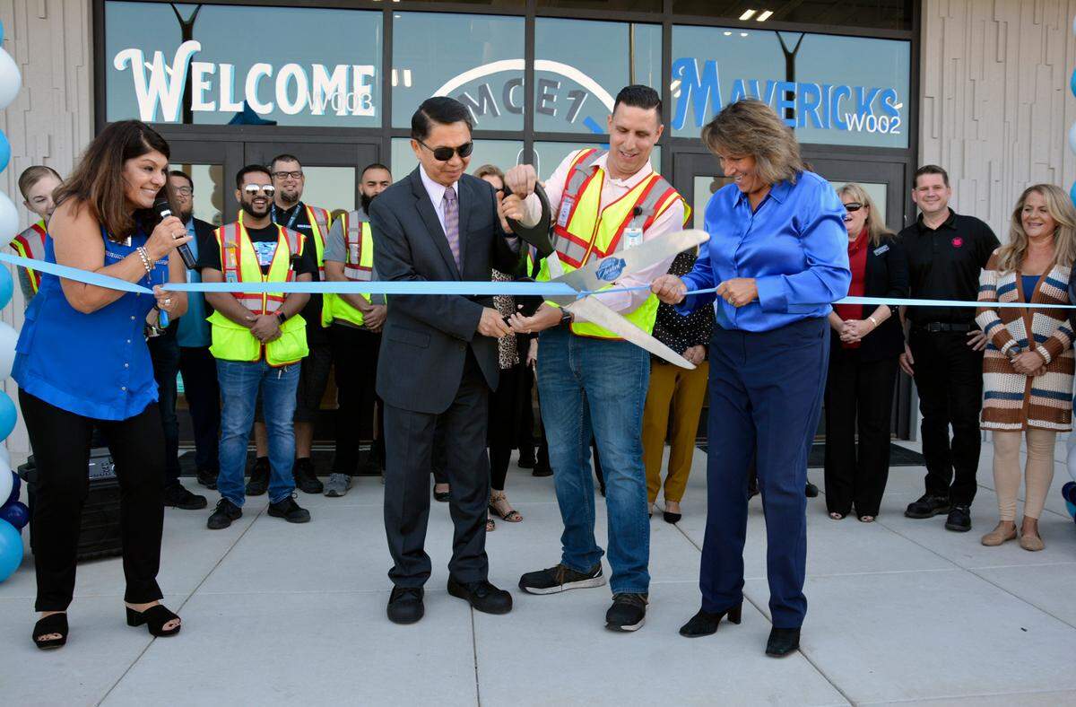 Turlock Chamber of Commerce Executive Director Gina Blom, left, and Yosemite Community College District Chancellor Henry Yong, Amazon Turlock Senior Operations Manager Steve Ramirez and Turlock Mayor Amy Bublak cut the ceremonial ribbon Thursday, Oct. 20, 2022, to open the new fulfillment center on Fulkerth Road in Turlock, Calif.