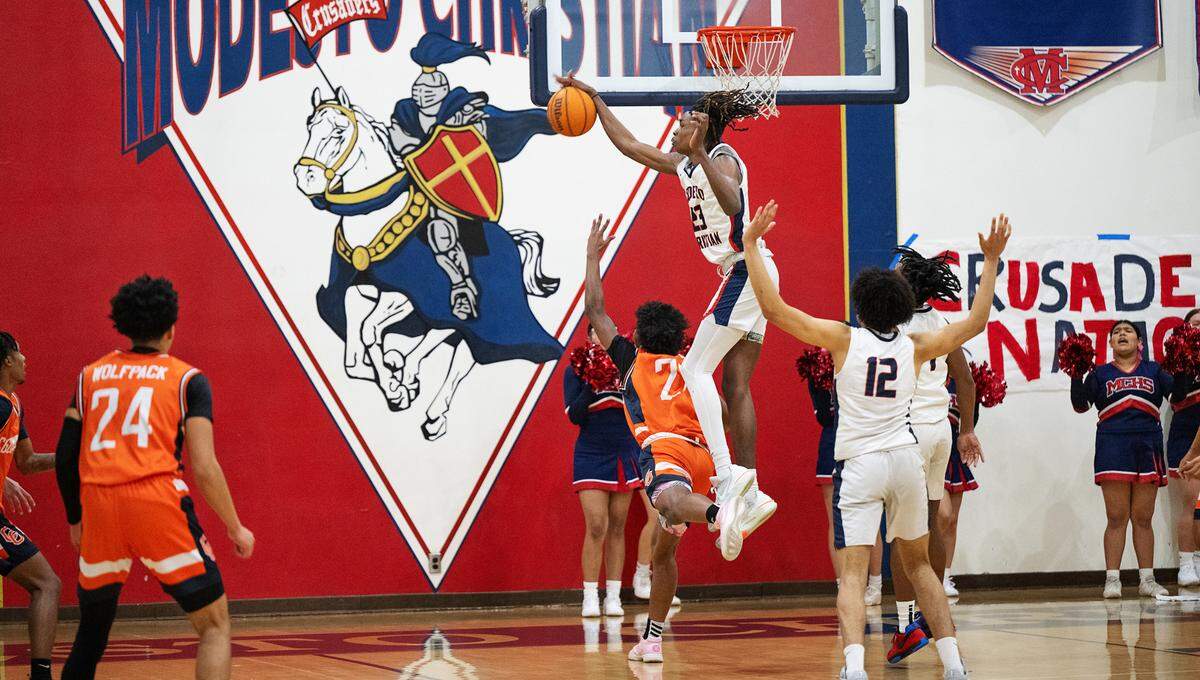 Modesto Christian’s Drevon Johnson blocks Cosumnes Oaks’ Henry Hill during the Sac-Joaquin Section Division I playoff game at Modesto Christian High School in Salida, Calif., Wednesday, Feb. 14, 2024.