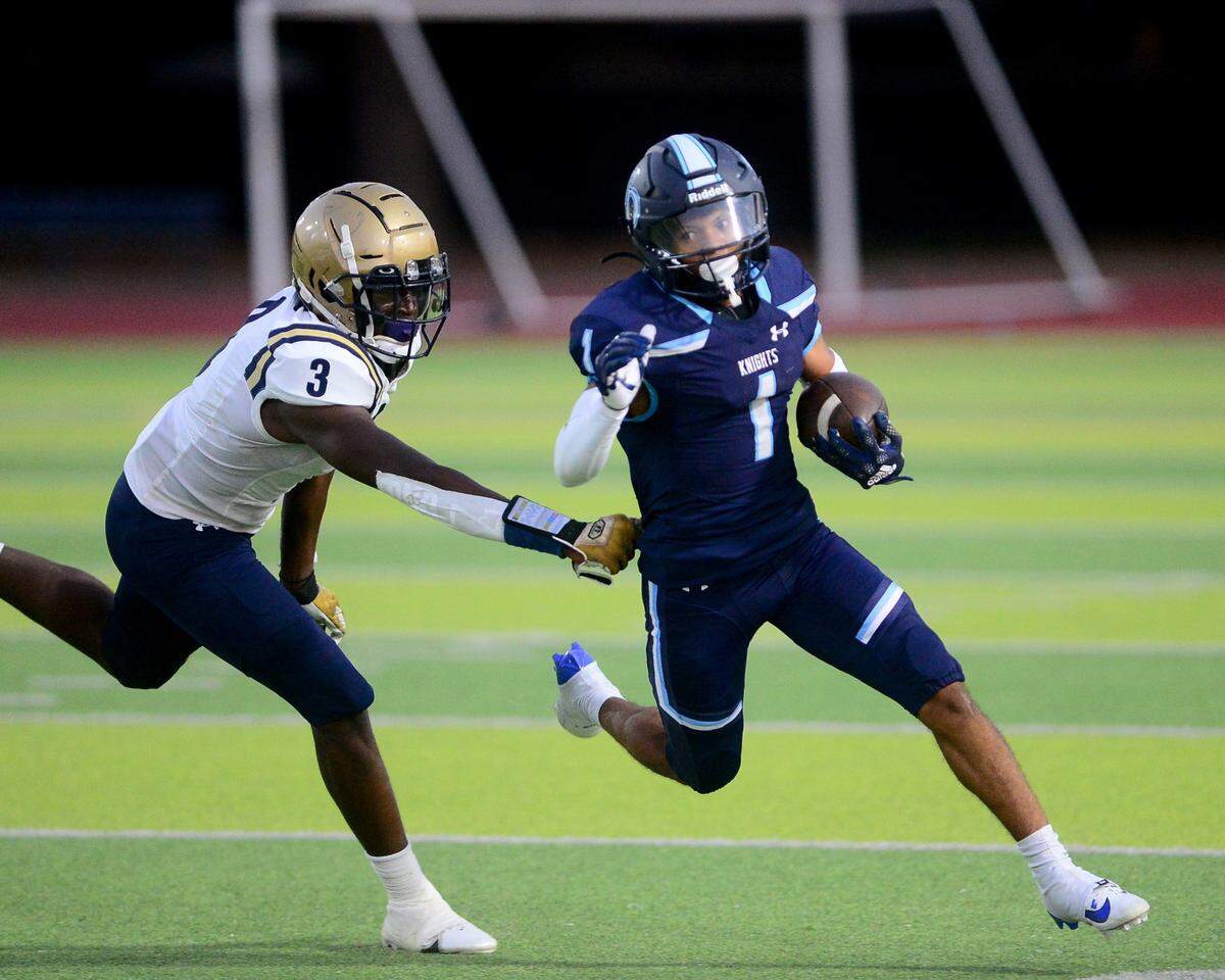 Downey running back Julius Padron (1) cuts past an Elk Grove defender during a game between Downey High School and Elk Grove High School at Downey High School in Modesto, Calif. on August 30, 2024.
