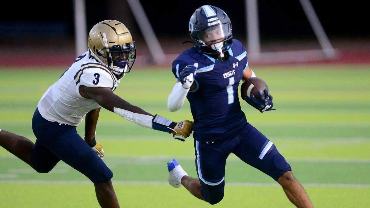 Downey running back Julius Padron (1) cuts past an Elk Grove defender during a game between Downey High School and Elk Grove High School at Downey High School in Modesto, Calif. on August 30, 2024.