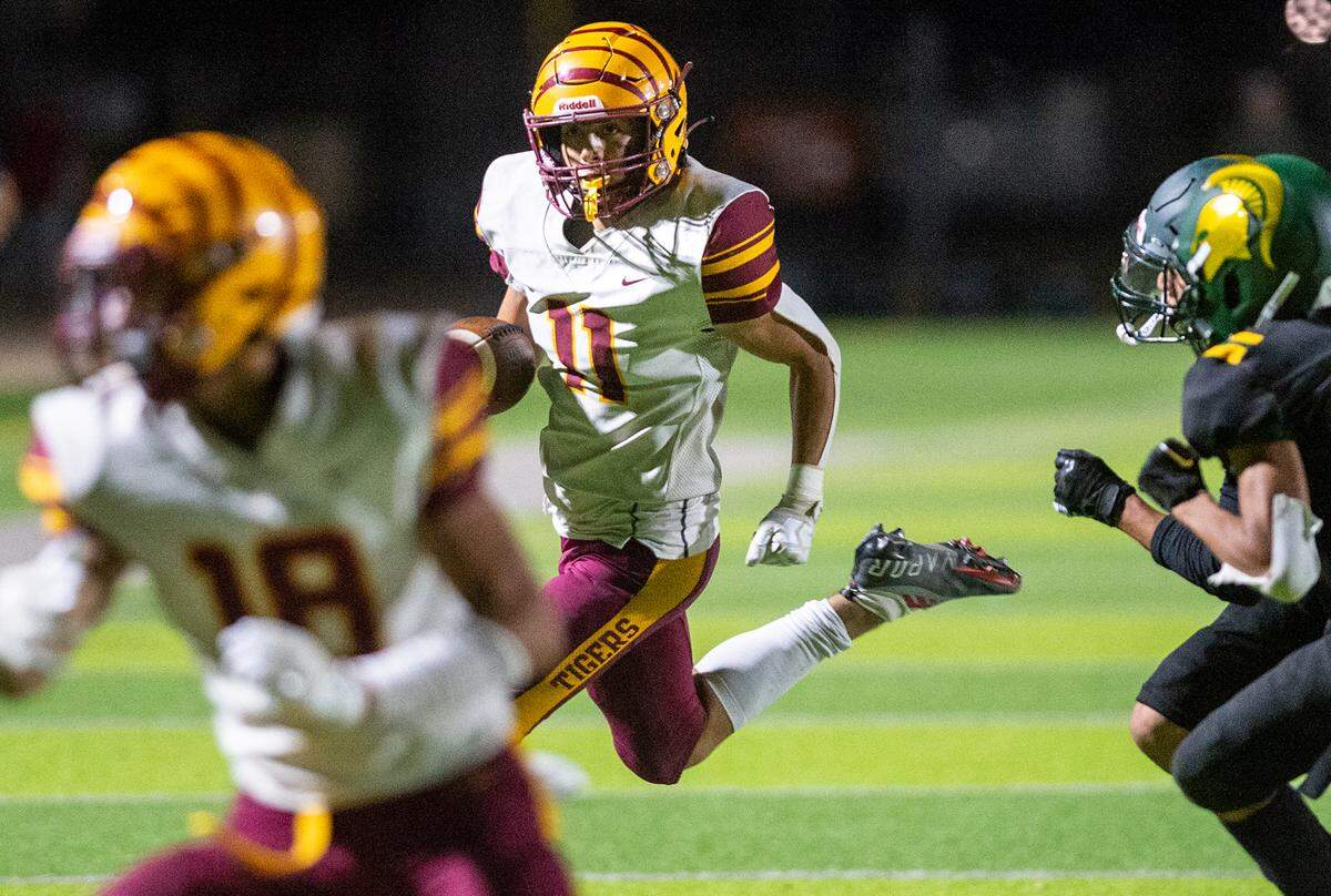 Los Banos’ Mark Carreiro runs the ball during a Western Athletic Conference game with Davis at Downey High School in Modesto, Calif., on Friday, September 23, 2022.