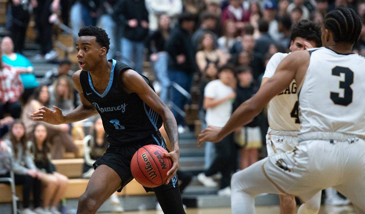 Downey’s Reuben Lewis drives to the basket during the Central California Athletic League game with Enochs at Enochs High School in Modesto, Calif., Friday, Jan. 27, 2023.
