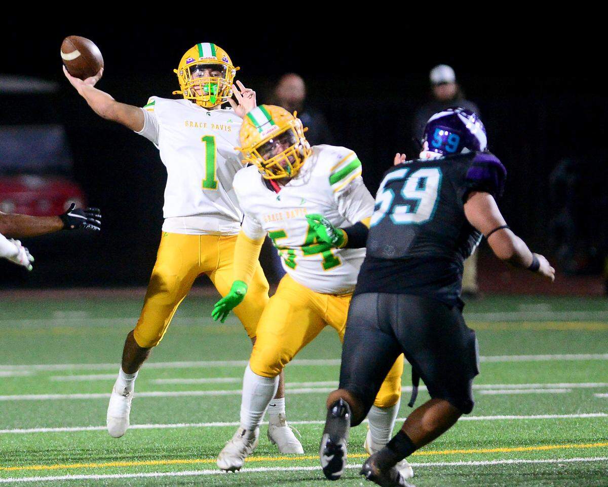 Davis quarterback Caleb Zaragoza (1) throws the ball deep down the middle of the field during a game between Johansen and Davis at Johansen High School in Modesto California on November 1, 2024.