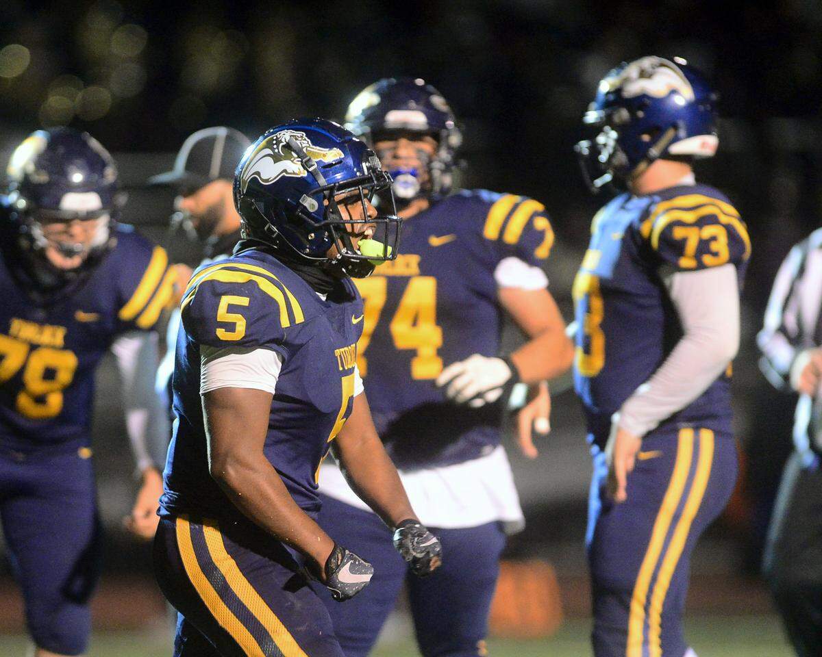 Turlock running back JT Foreman II (5) flexes in celebration after scoring a touchdown during a CIF Division I CIF Sac-Joaquin Section Football Playoff game between Turlock High School and Edison High School at Turlock High School in Turlock CA on November 4, 2022. Turlock won 35-0.
