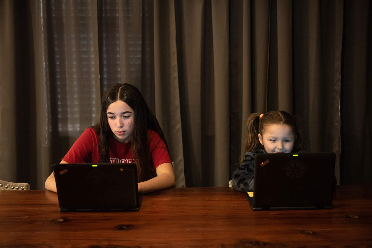9th-grade student Felicity Fernandez, 14, and her niece Cataleya Fernandez, 5, use the LTE internet service provided by Patterson school district in Patterson, Calif., on Friday, Jan. 15, 2021.