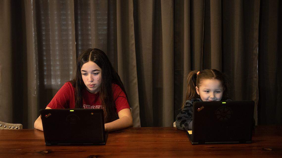 9th-grade student Felicity Fernandez, 14, and her niece Cataleya Fernandez, 5, use the LTE internet service provided by Patterson school district in Patterson, Calif., on Friday, Jan. 15, 2021.