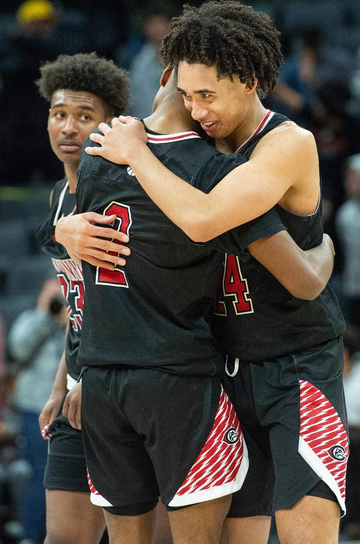 Centennial’s Jared McCain hugs teammate Donovan Dent after the Huskies 59-50 victory over Modesto Christian in the boys Open Division CIF State Basketball Championship game at Golden 1 Center in Sacramento, Calif., on Saturday, March 12, 2022.