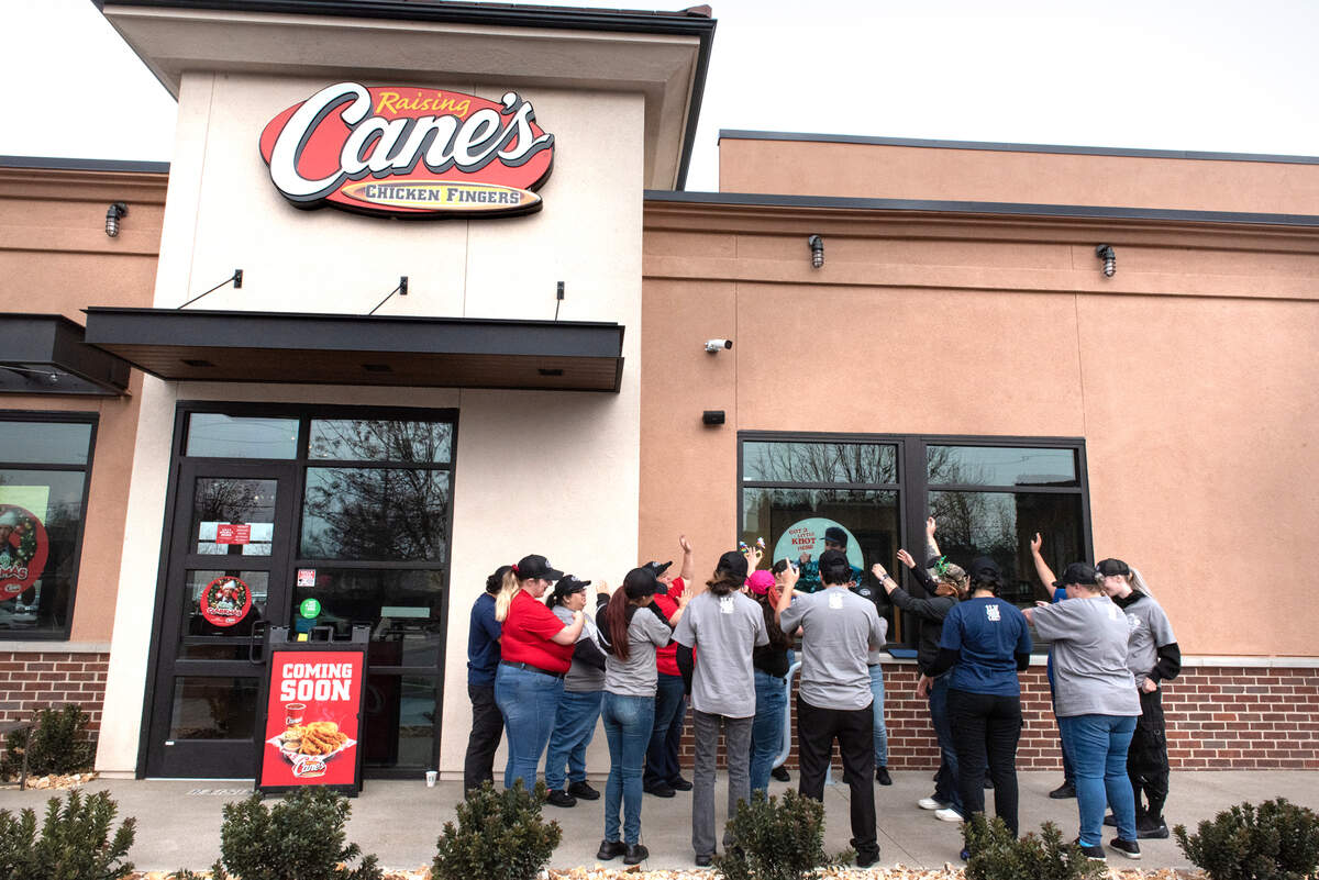 Employees participate in a team cheer during training in preparation for Monday’s grand opening at Raising Cane’s Chicken Fingers restaurant in Modesto, Calif., Friday, Dec. 16, 2022.