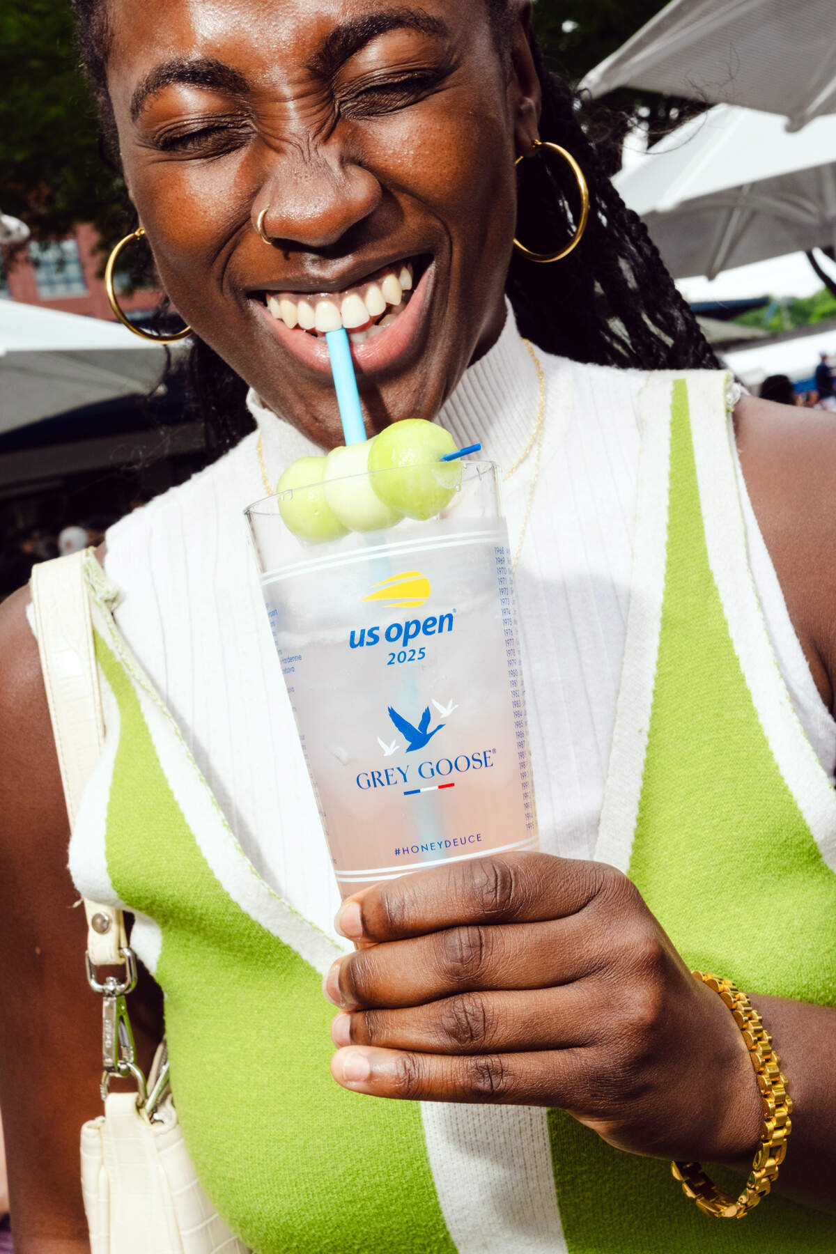 A tennis fan enjoys at honeydeuce cocktail at the U.S. Open in New York on Aug. 21, 2025. The cherry-blossom-pink vodka concoction is entering its 18th year as the event’s signature drink. And it’s still a cash cow.