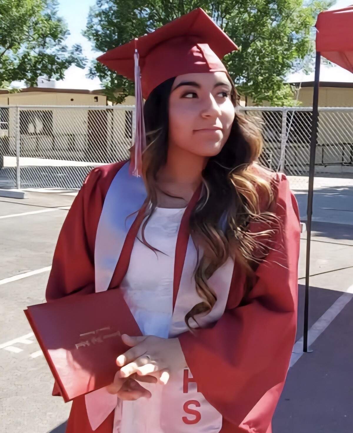 Anisa Lucero poses for a graduation photo in an image shared on a GoFundMe fundraiser created to support her family after her death. Friends organized the fundraiser to help the family with funeral expenses and other unexpected costs.