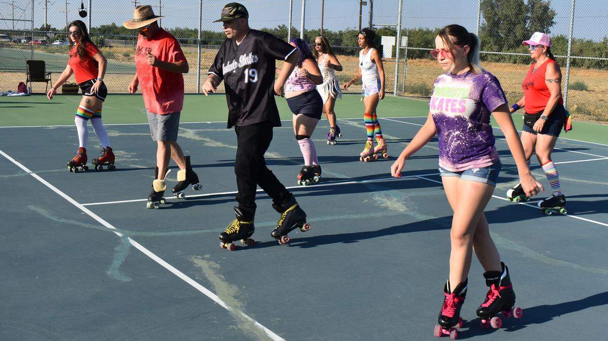 Members of the Modesto Skates group, including front row, from left, Samantha Ortega, Lauren Ringgenberg, Brian Cromwell and Alexis Lacayo, roller-dance to music on tennis courts at Johansen High School on Sunday evening, Aug. 8, 2021.
