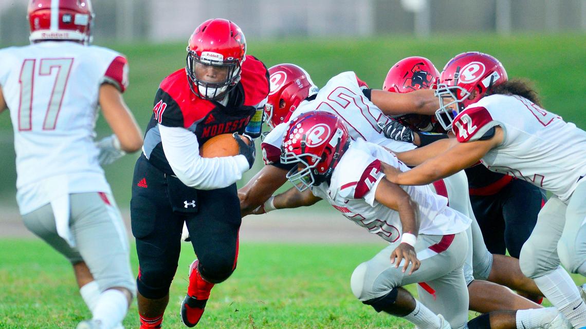 Modesto’s James Hayes (41) bounces off multiple defenders during a game between Modesto High School and Patterson High School at Gregori High School in Modesto California on September 13, 2019.