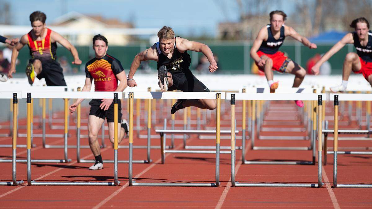 Larkin Meyer is way out front of the competition in the 100m hurdles during the Stanislaus County track meet at Hughson High School in Hughson, Calif., Friday, March 24, 2023. Meyer won with a time of 15.52. Cameron Guthrie of Oakdale was second at 16.41.