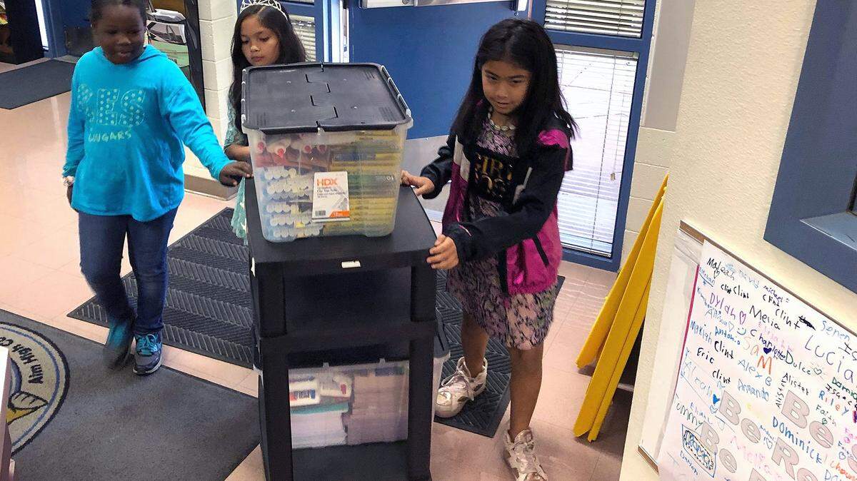 Capistrano Elementary student body officers Maxine Pollard, secretary, Emily Rontal, vice president, and Dahlia Lucero, treasurer, wheel donated school supplies through the school office on Tuesday morning, Oct. 8, 2019, in Modesto.
