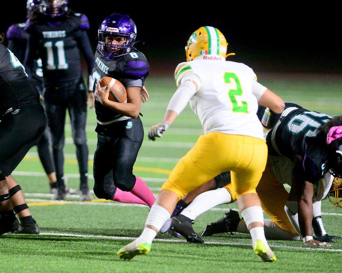 Johansen running back Ezekiel Rodriguez (8) slips through blockers during a game between Johansen and Davis at Johansen High School in Modesto California on November 1, 2024.