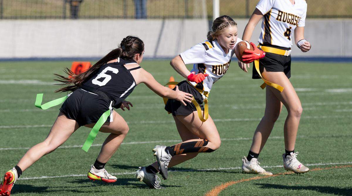 Hughson’s Morgan Bleakley runs the ball as Colfax defender Maddie Fee attempts a tackle during the Sac-Joaquin Section Division 4 championship game at Cosumnes River College in Sacramento, Saturday, Nov. 9, 2024.