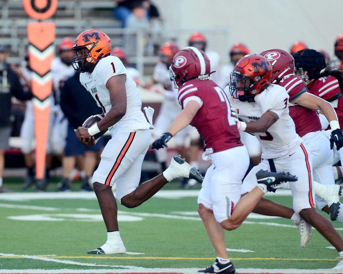 Merced quarterback Quintell Dupree (1) runs from the Patterson defense on a scramble during a game between Patterson High School and Merced High School at Patterson High on Aug. 23, 2024.