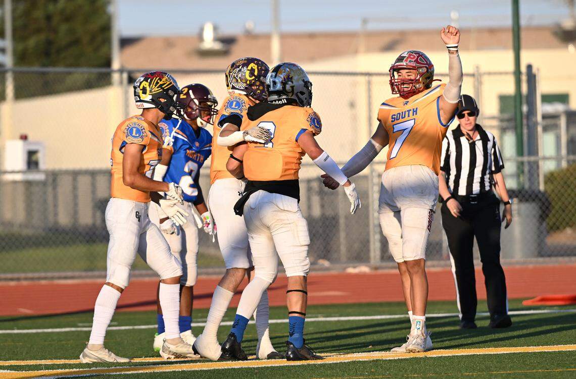 South team quarterback Eleazar Garcia, right, (Golden Valley) celebrates a touchdown pass to teammate Joey Stout (3) (Pitman) during the Central California Lions All-Star Football Game at Tracy High School in Tracy, Calif., Saturday, June 24, 2023. The South won the game 38-13.