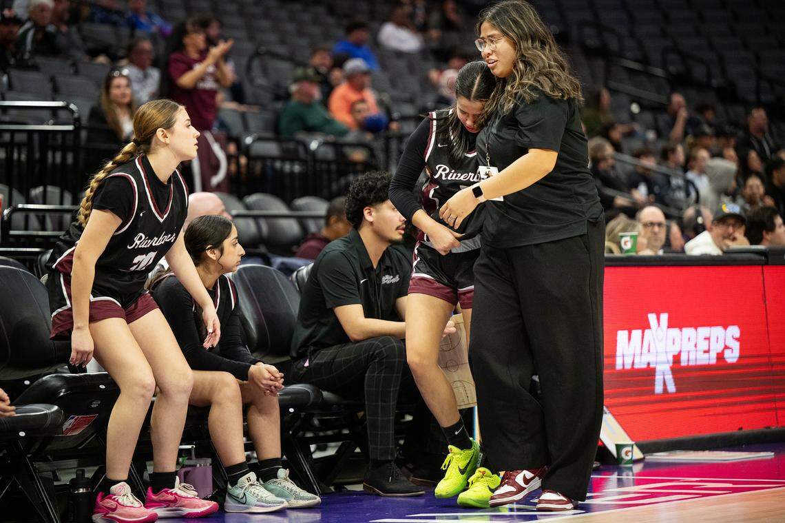 Riverbank head coach Janelle Luu comforts Leilani Olanolan after she fouled out of the game in the the Sac-Joaquin Section D-4 championship game at the Golden 1 Center in Sacramento, Thursday, February, 27, 2025.