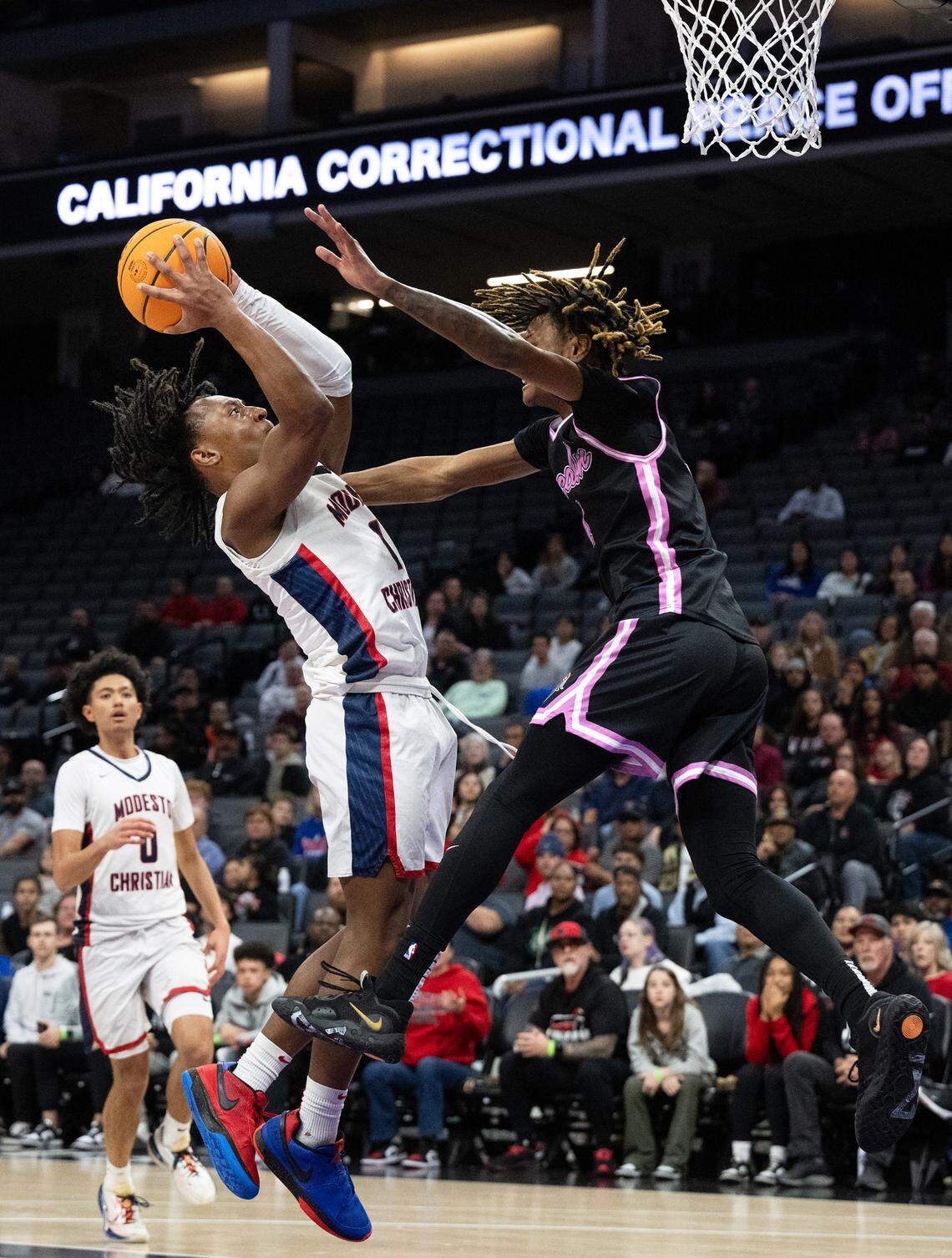 Modesto Christian’s Jeremiah Bernard drives to the basket as Lincoln’s Zeke Davis defends during the Sac-Joaquin Section Division I championship game at the Golden 1 Center in Sacramento, Calif., Wednesday, Feb. 21, 2024.