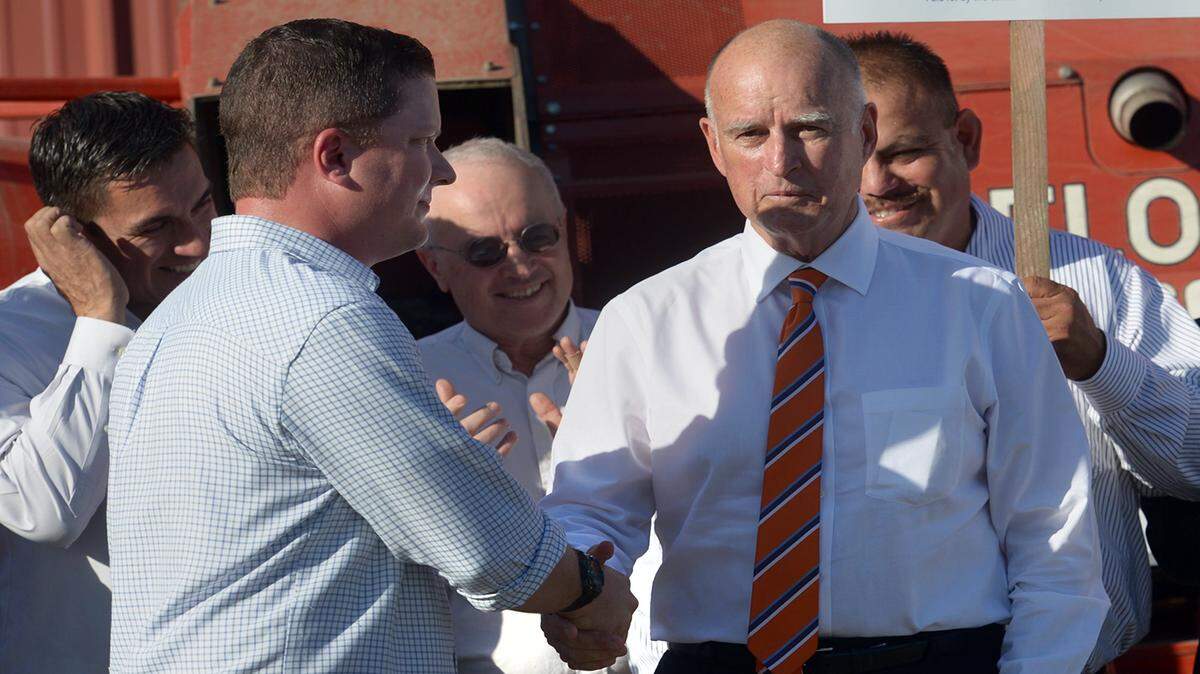 Jake Wenger shakes hands with California governor, Jerry Brown after his speech in a press conference to urge yes votes for Propositions 1 and 2, in Modesto, Oct. 29, 2014. 